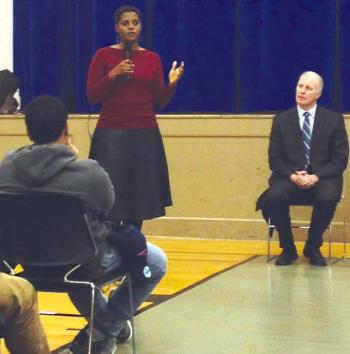 Natashia Tidwell, (left)  a member of the city’s Community Ombudsman Oversight Panel, spoke during a public meeting on police-community relations held at St. Peter’s Teen Center. Seated at right is Eugene O’Flaherty, the Corporation Counsel for the City of Boston. Eliza Dewey photo